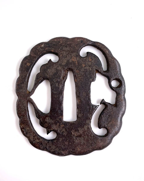 Antique Edo-period iron tsuba with chrysanthemum-shaped rim and elegant sukashi openwork, approximately 8 cm in diameter.