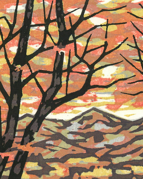 Small 2003 woodblock print by Fumio Fujita depicting silhouetted trees before distant mountains beneath a warm autumn sky.