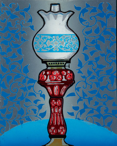 Decorative oil lamp with red base on a blue background
