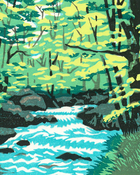 Handmade woodblock print of a forest stream with green trees and rocks.