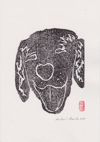 Black and white handmade woodblock print of a laughing dog on a light beige background