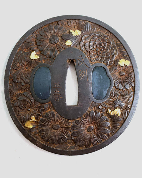 Antique Edo Era metal tsuba with floral patterns and gold inlay