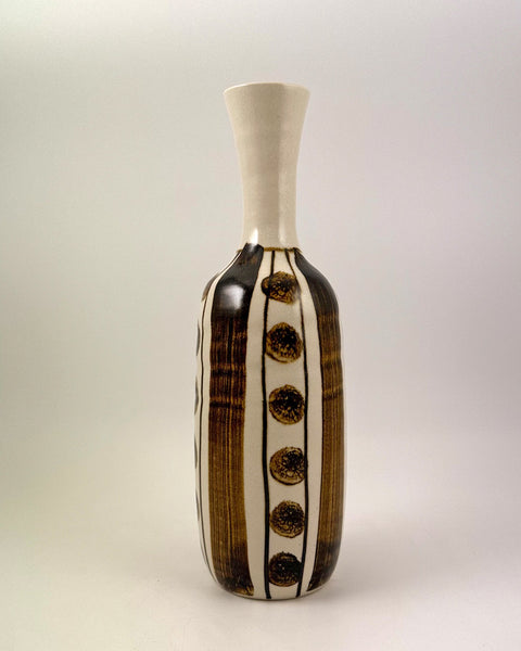 Vintage Japanese studio pottery bottle vase with iron-brown brush decoration and repeating circular motifs on a warm ivory glaze.