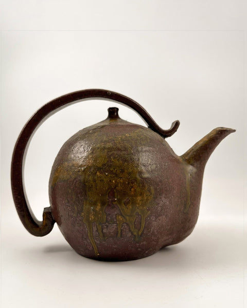 Vintage earthenware teapot with a decorative handle background