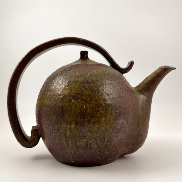 Vintage earthenware teapot with a decorative handle background