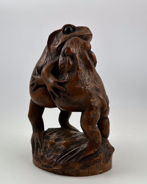 Antique Japanese bamboo root sculpture depicting two frogs wrestling like sumo wrestlers with rich brown patina.