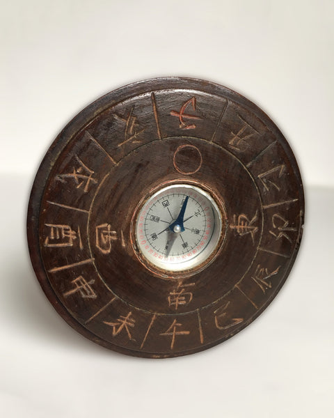 Hand-carved Japanese wooden zodiac direction compass with twelve zodiac characters surrounding an inset magnetic compass.